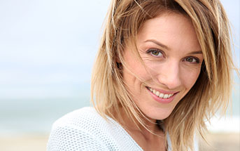 image of a woman smiling and feeling youthful after having a facial